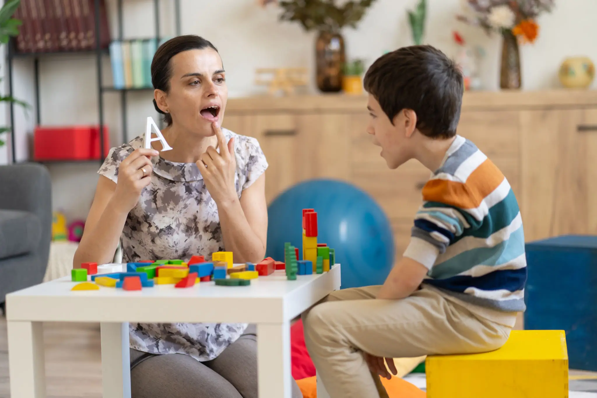 Speech therapist practicing sounds with boy